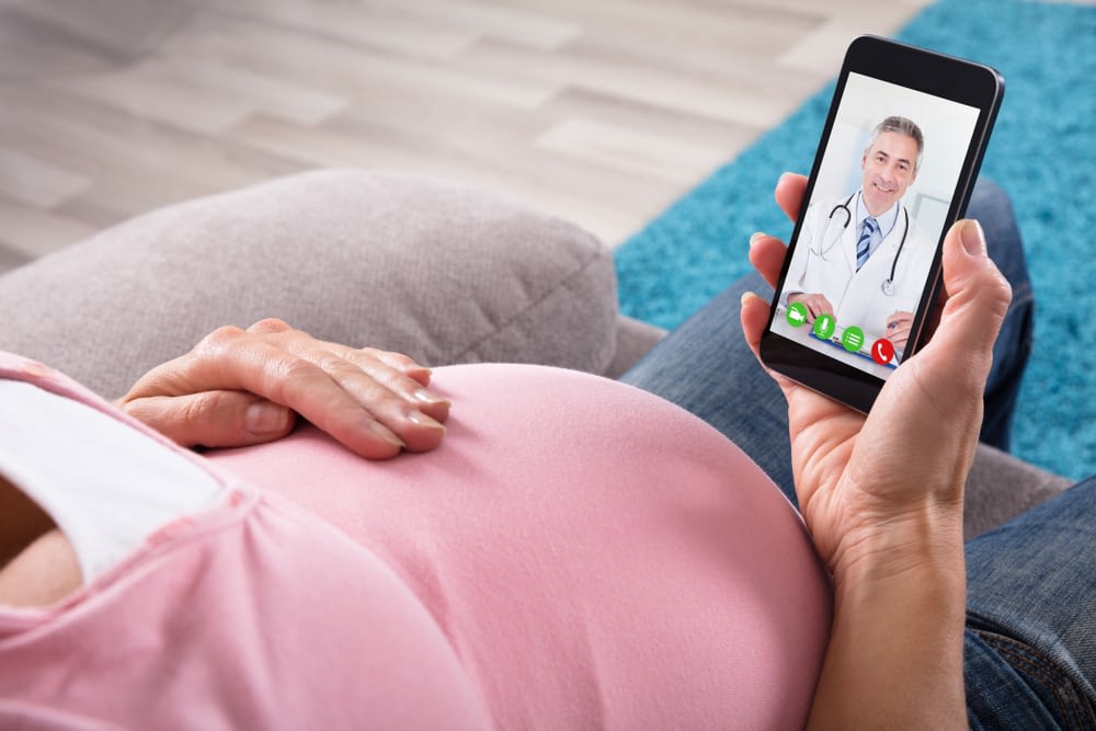 Doctor Communicating With patient via mobile phone